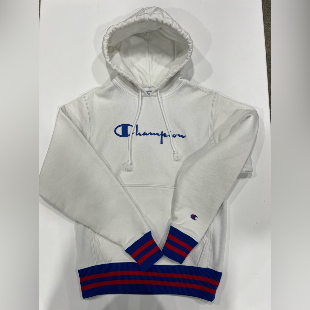 Champion Reverse Weave White Hoodie with Blue and Red Accents.